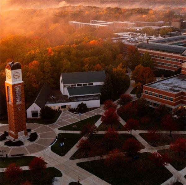 The carillon is at the center of an image of the Allendale Campus during sunrise.