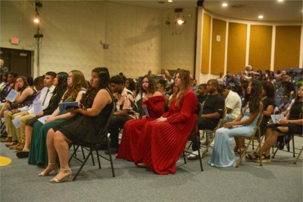 students seated in chairs in rows